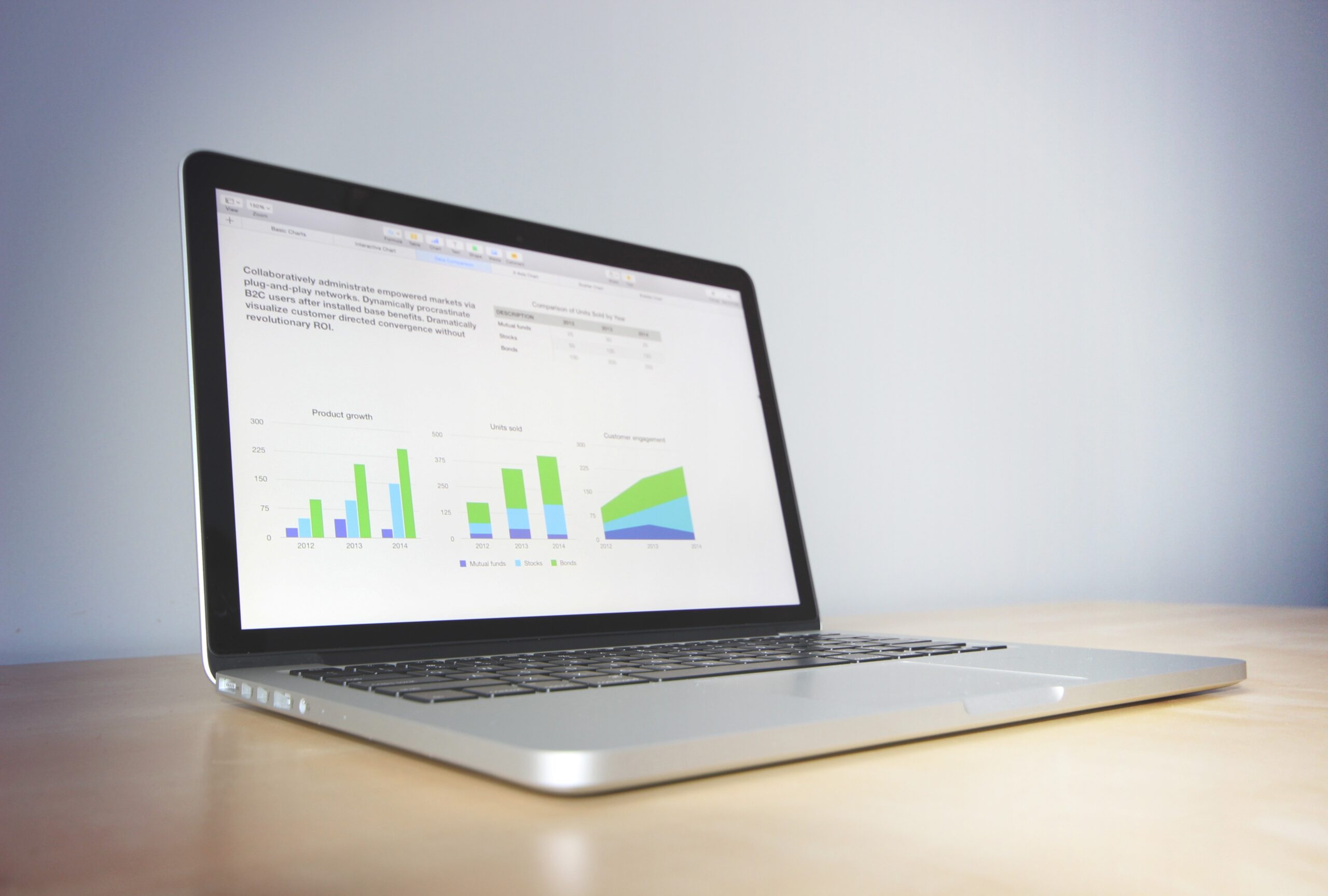 a laptop with a graph on the screen showing remote access to bookkeeping reports